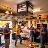 Friends watching the game under the COURTBOX in a garage